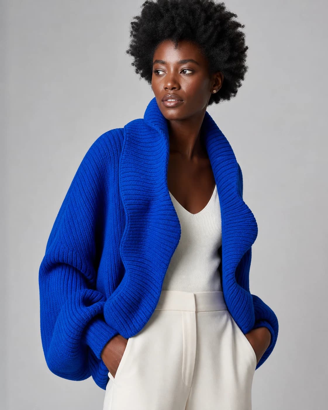 AI-generated model wearing a cobalt knit cardigan