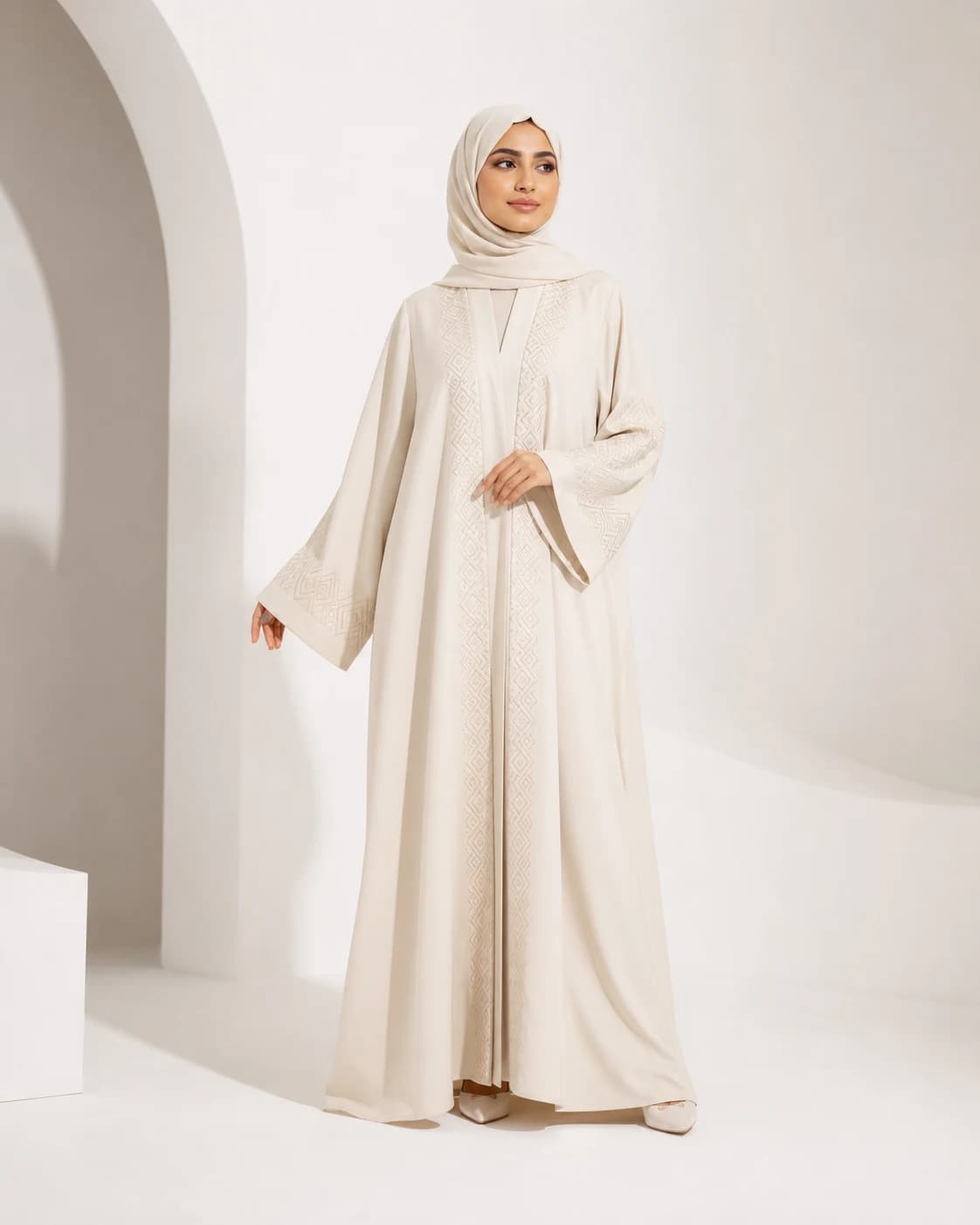 AI-generated model wearing an ivory embroidered abaya in a white studio